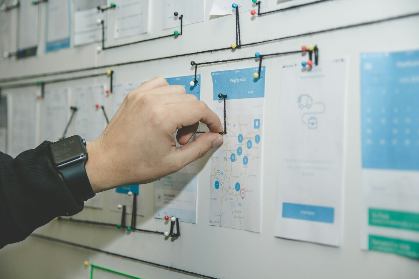 A person planning a workflow on a whiteboard